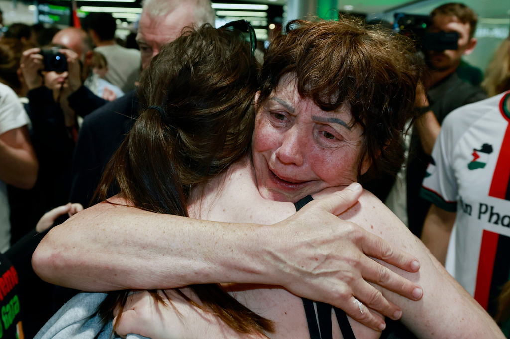 Margaret Connolly, right, embraces her daughter, Katie, at Dublin Airport as twelve Irish citizens who were detained by Israel arrive back in Ireland, Saturday, May 23, 2026. (Conor O Mearain/PA via AP)