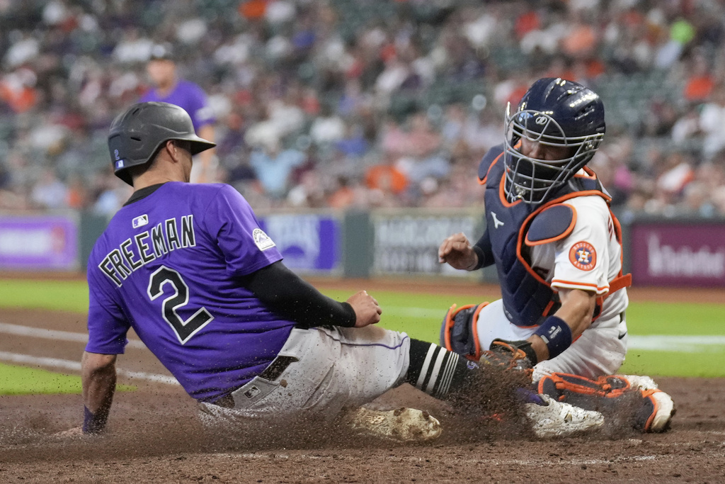 Colorado Rockies' Tyler Freeman (2) is tagged out at home plate by Houston Astros catcher César Salazar during the fifth inning of a baseball game Thursday, Aug. 28, 2025, in Houston. (AP Photo/David J. Phillip)