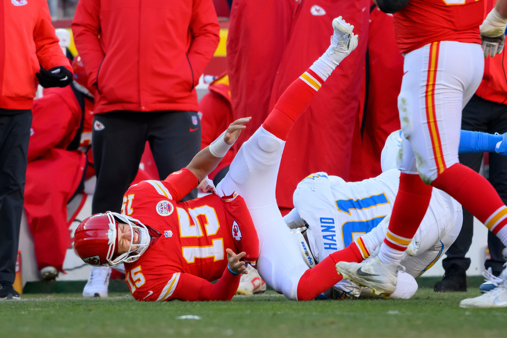 FILE - Kansas City Chiefs quarterback Patrick Mahomes (15) is injured while being tackled by Los Angeles Chargers defensive tackle Da'Shawn Hand (91) during the second half of an NFL football game, Dec. 14, 2025 in Kansas City, Mo. (AP Photo/Reed Hoffmann, File)
