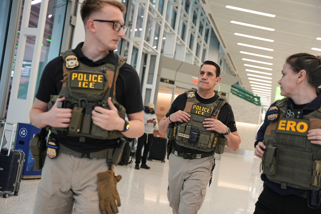 Federal immigration agents are seen at Newark Liberty International Airport, Monday, March 23, 2026, in Newark, N.J. (AP Photo/Angelina Katsanis)