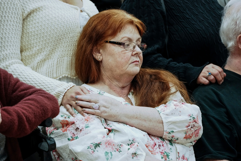 A family member of the victims listens Suffolk County District Attorney Raymond A. Tierney during a press conference after Rex Heuermann, was accused in Long Island's infamous Gilgo Beach serial killings, pleaded guilty on Wednesday, April 8, 2026, at Suffolk County Police Academy Gymnasium in Brentwood, New York. (AP Photo/Eduardo Munoz Alvarez)