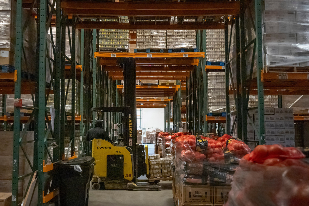 An employee drives a forklift at a warehouse of the Capital Area Food Bank, Thursday, Nov. 6, 2025, in Washington. (AP Photo/Mark Schiefelbein)