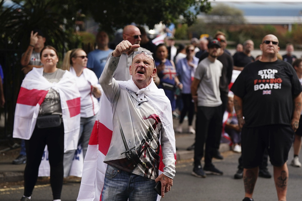 People demonstrating under the Abolish Asylum System slogan outside the Castle Bromwich Holiday Inn in Birmingham, England, Sunday, Aug. 24, 2025. (Jacob King/PA via AP)