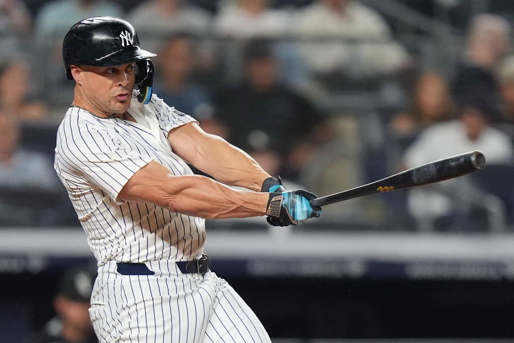 New York Yankees' Giancarlo Stanton follows through on a three-run double during the fifth inning of a baseball game against the Chicago White Sox Thursday, Sept. 25, 2025, in New York. (AP Photo/Frank Franklin II)