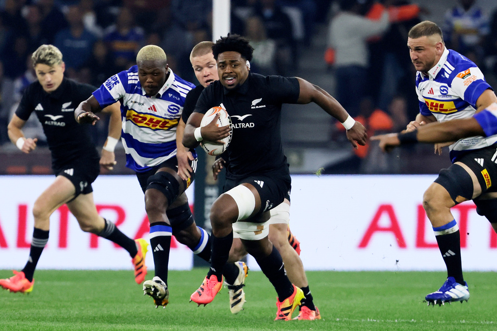 All Blacks' Peter Lakai, center, breaks away from Stromers' players during a friendly rugby match between Stormers and All Blacks, in Cape Town, South Africa, Friday, Aug. 7, 2026. (AP Photo/Halden Krog)