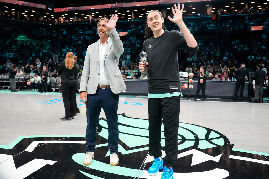 The Associated Press' Global Sports Editor Josh Hoffner, left, presents the Greatest Player award to New York Liberty forward Breanna Stewart ahead of a WNBA basketball game against the Dallas Wings, Tuesday, July 7, 2026, in New York. (AP Photo/Yuki Iwamura)