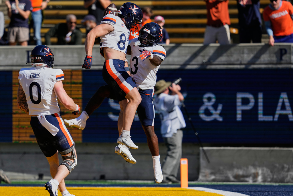 Virginia running back J'Mari Taylor (3), right, celebrates with wide receiver Eli Wood, center, after scoring a touchdown during the first half of an NCAA college football game against California, Saturday, Nov. 1, 2025, in Berkeley, Calif. (AP Photo/Godofredo A. Vásquez)