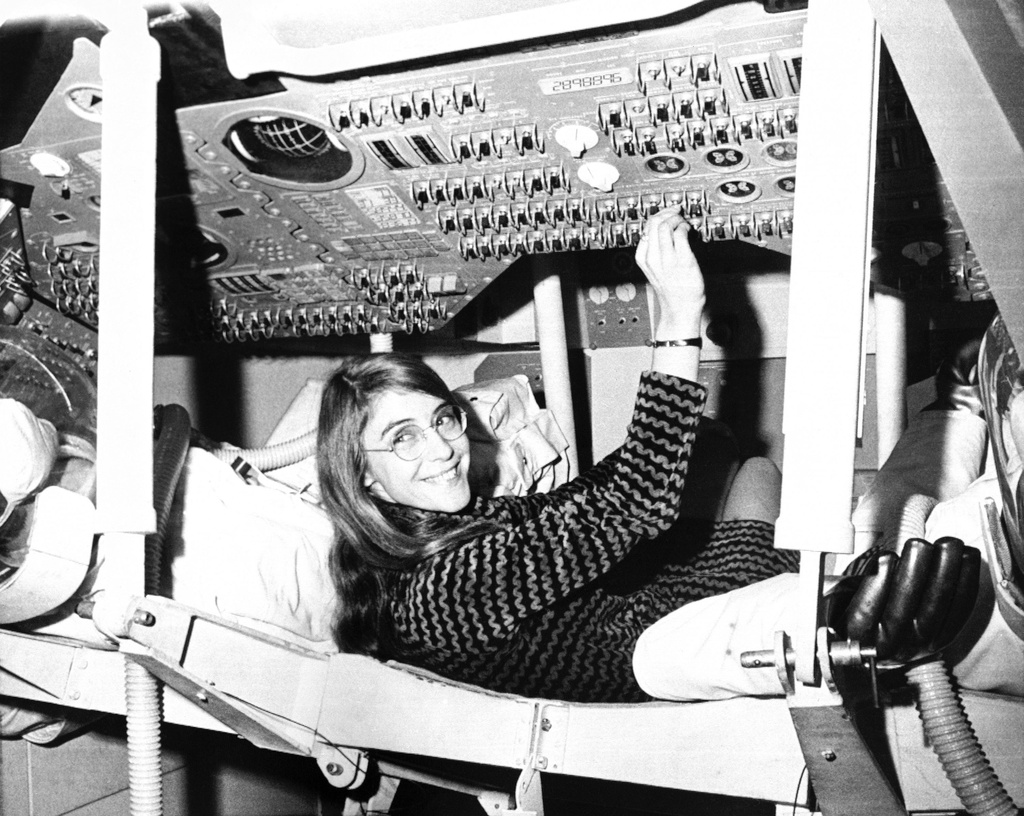 FILE - Margaret Hamilton, of Cambridge, Mass., mathematic and computer programmer at the MIT Instrumentation Laboratory, sits in mock up of Apollo command module on display at the Cambridge school, Nov. 25, 1969, where she headed group that programmed Intrepid's pinpoint landing in the Sea of Storms on the moon. (AP Photo/File)