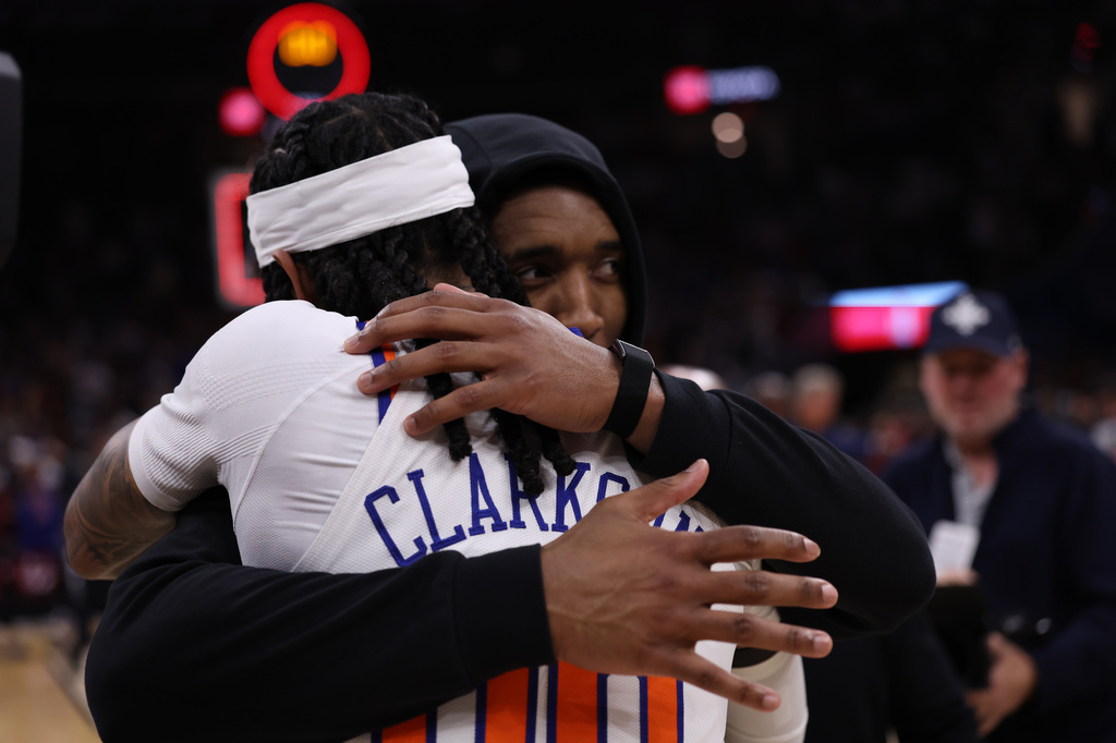 Cleveland Cavaliers guard Donovan Mitchell, right, hugs New York Knicks guard Jordan Clarkson (00) after Game 4 in the Eastern Conference finals NBA basketball playoffs series in Cleveland, Monday, May 25, 2026. (AP Photo/Tim Phillis)