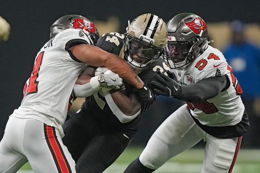 New Orleans Saints running back Devin Neal (24) is stopped by Tampa Bay Buccaneers safety Antoine Winfield Jr. (31) and linebacker Lavonte David (54) during the first half of an NFL football game Sunday, Oct. 26, 2025, in New Orleans. (AP Photo/Gerald Herbert) New Orleans Saints running back Devin Neal (24) is stopped by Tampa Bay Buccaneers safety Antoine Winfield Jr. (31) and linebacker Lavonte David (54) during the first half of an NFL football game Sunday, Oct. 26, 2025, in New Orleans. (AP Photo/Gerald Herbert)