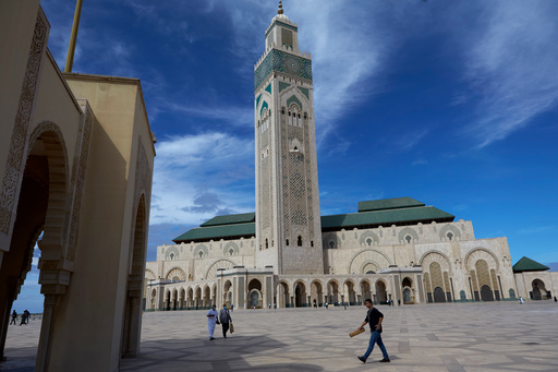 FILE - People walk past the great Hassan II Mosque in Casablanca, Morocco, Oct. 16, 2020. (AP Photo/Abdeljalil Bounhar, File) FILE - People walk past the great Hassan II Mosque in Casablanca, Morocco, Oct. 16, 2020. (AP Photo/Abdeljalil Bounhar, File)