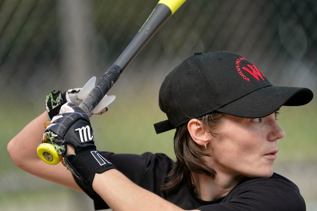 Brittany Apgar, who was born without a right hand, prepares to hit at a field in Greensboro, N.C., Wednesday, July 22, 2026 before joining the Los Angeles team in the Women's Pro Baseball League. (AP Photo/Chuck Burton)