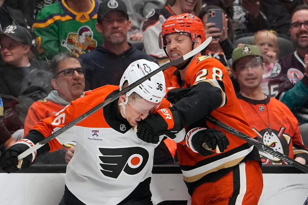 Anaheim Ducks left wing Jeffrey Viel, right, punches Philadelphia Flyers defenseman Emil Andrae during the second period of an NHL hockey game Wednesday, March 18, 2026, in Anaheim, Calif. (AP Photo/Mark J. Terrill)
