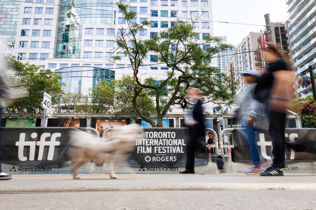 People walk past the signage for the Toronto International Film Festival in Toronto, on Thursday, Sept. 10, 2026. (Keito Newman/The Canadian Press via AP)