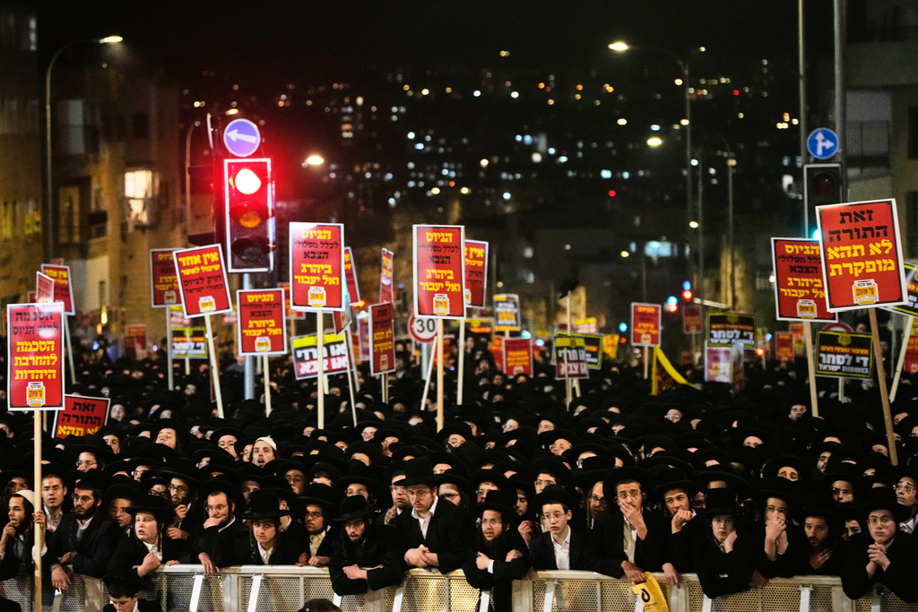 Ultra-Orthodox Jewish men protest against army recruitment in Jerusalem, Tuesday, Jan. 6, 2026. (AP Photo/Ohad Zwigenberg)