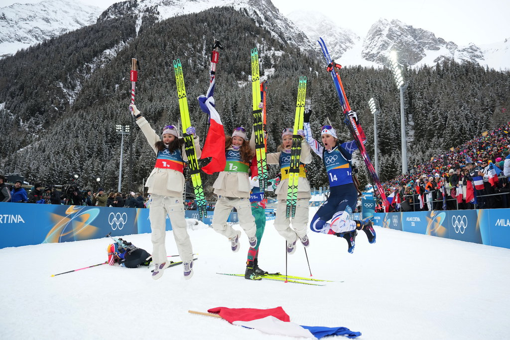 France's Camille Bened, from left, Lou Jeanmonnot, Oceane Michelon and Julia Simon, celebrate winning gold in the women's 4x6-kilometer relay biathlon race at the 2026 Winter Olympics in Anterselva, Italy, Wednesday, Feb. 18, 2026. (AP Photo/Andrew Medichini)