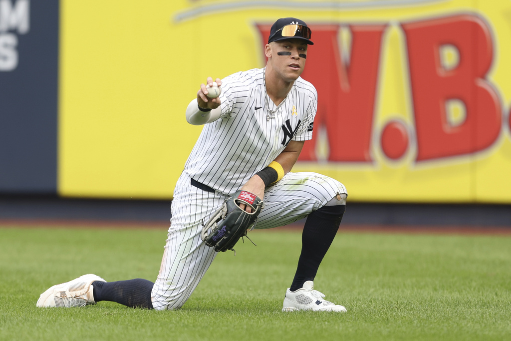 New York Yankees outfielder Aaron Judge shows the ball after making a diving catch during the fourth inning of a baseball game against the Toronto Blue Jays, Sunday, Sept. 7, 2025, in New York. (AP Photo/Heather Khalifa)