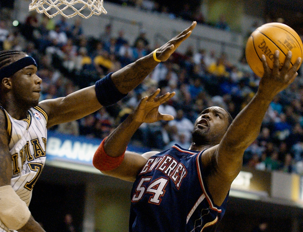 FILE - New Jersey Nets forward Rodney Rogers puts up a shot against Indiana Pacers forward Jermaine O'Neal during the first quarter of a basketball game in Indianapolis, April 9, 2004. (AP Photo/Darron Cummings, File)