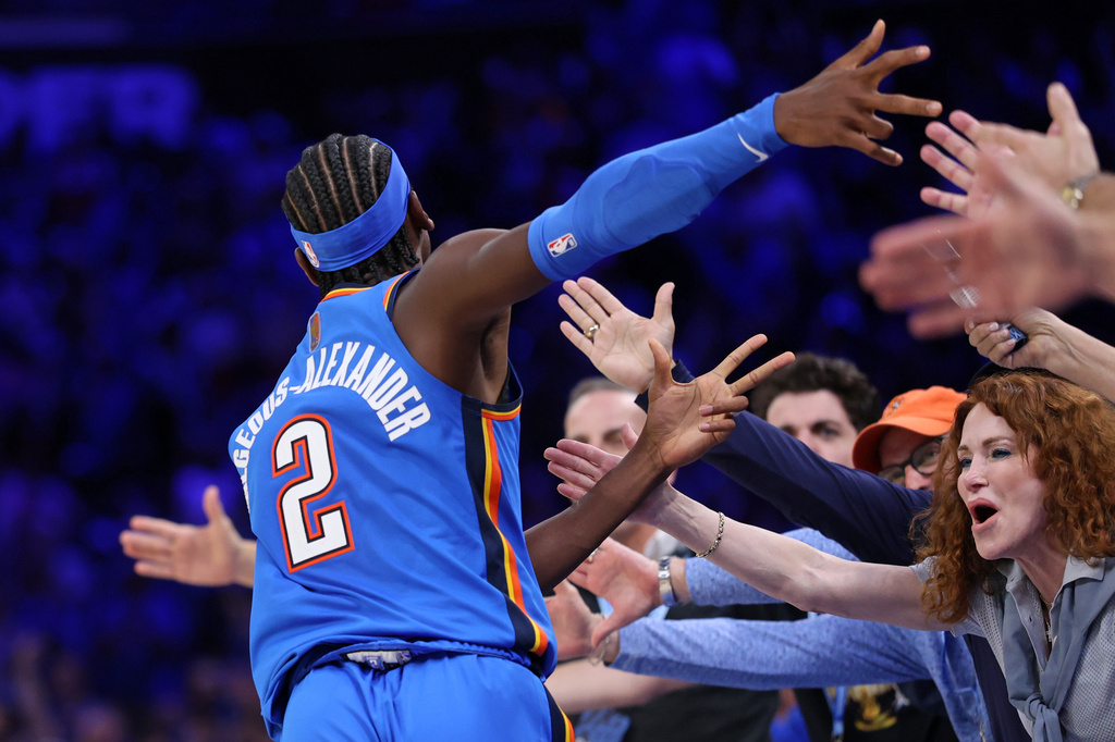 Oklahoma City Thunder guard Shai Gilgeous-Alexander celebrates with fans after making a basket during the second half of an NBA basketball game against the Denver Nuggets, Thursday, Oct. 22, 2026, in Oklahoma City. (AP Photo/Nate Billings)