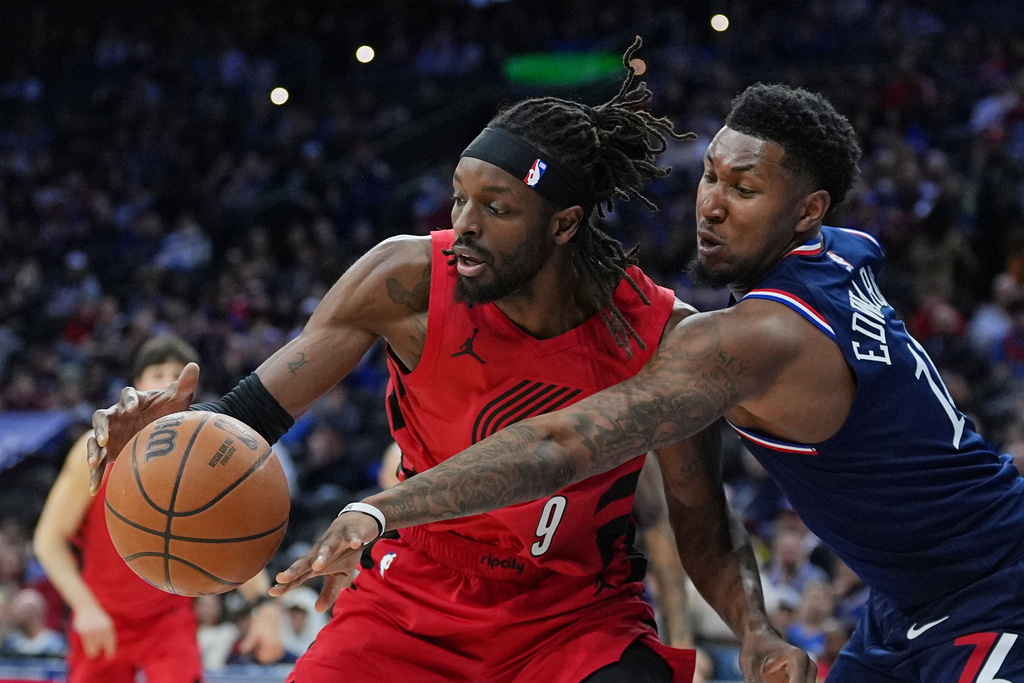 Portland Trail Blazers' Jerami Grant (9) tries to get past Philadelphia 76ers' Justin Edwards during the first half of an NBA basketball game, Sunday, March 15, 2026, in Philadelphia. (AP Photo/Matt Rourke)