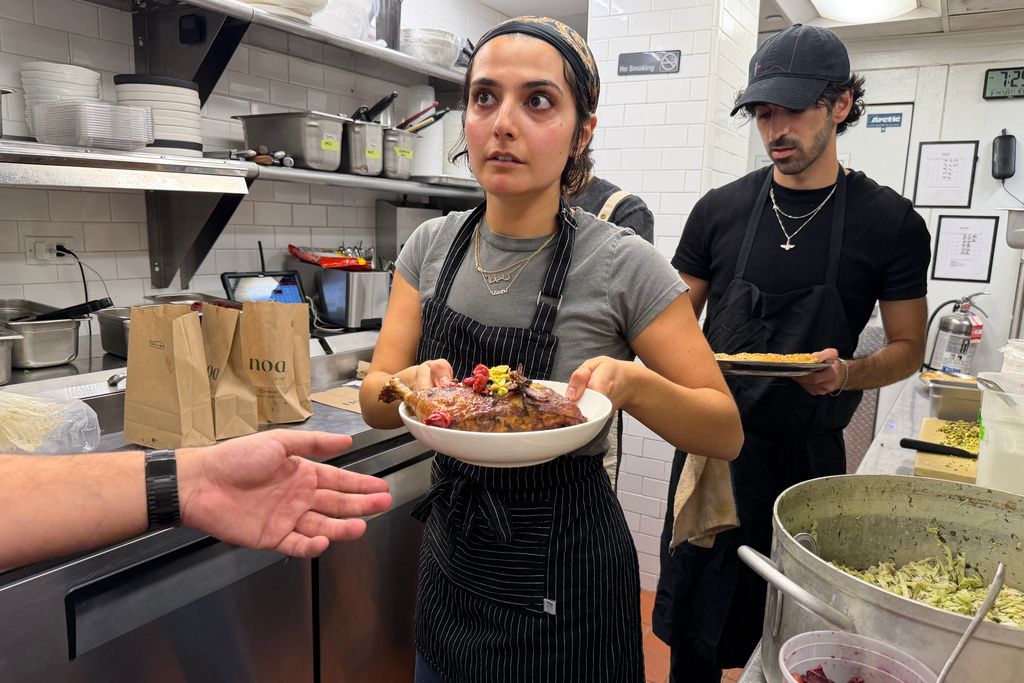 Anais Dersi, one of the chefs and organizers of a Persian pop-up dinner to celebrate Nowruz, prepares Iranian dishes in New York on Saturday, March 14, 2026. (AP Photo/J.M. Hirsch)