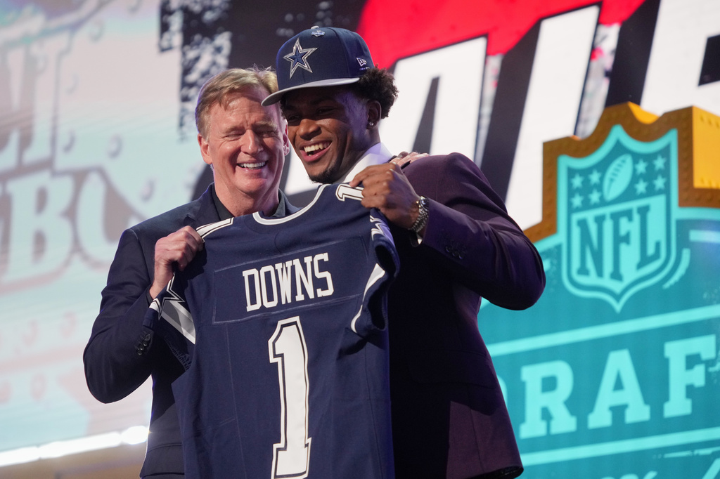 Ohio State defensive back Caleb Downs poses with NFL Commissioner Roger Goodell after being chosen by the Dallas Cowboys with the 11th overall pick during the first round of the NFL football draft, Thursday, April 23, 2026, in Pittsburgh. (AP Photo/Gene J. Puskar)