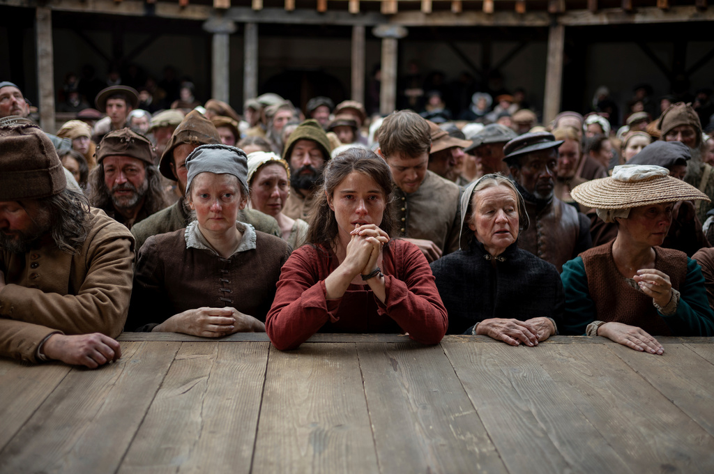 This image released by Focus Features shows Jessie Buckley, center, in a scene from "Hamnet." (Agata Grzybowska/Focus Features via AP)