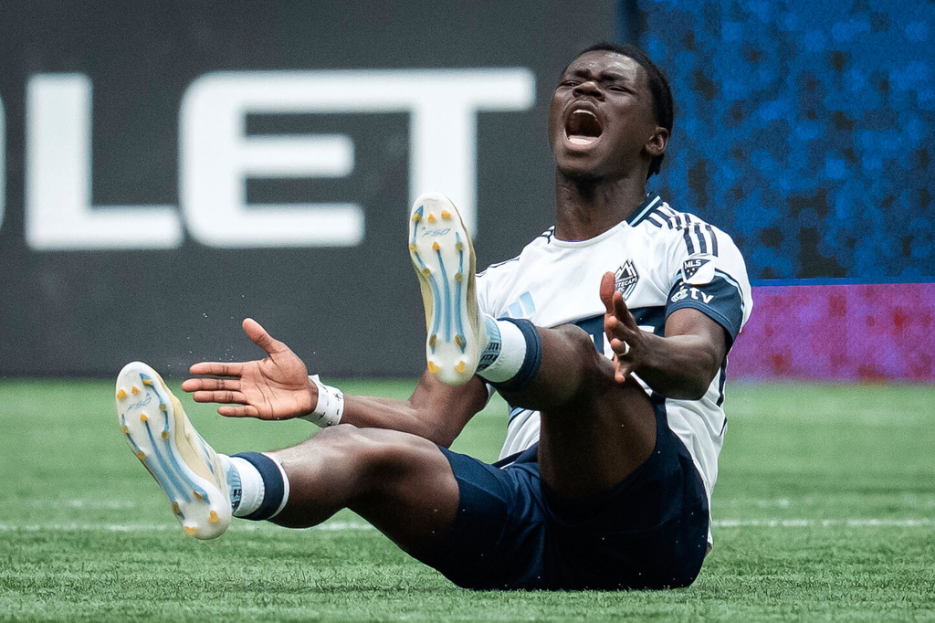 Vancouver Whitecaps' Emmanuel Sabbi protests after being tripped during the first half of an MLS soccer match against the Houston Dynamo in Vancouver, British Columbia, Sunday, Aug. 17, 2025. (Ethan Cairns/The Canadian Press via AP)