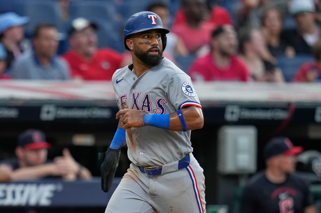 Texas Rangers' Ezequiel Duran runs towards home plate to score on an error by Cleveland Guardians left fielder Cooper Ingle in the seventh inning of a baseball game in Cleveland, Tuesday, June 30, 2026. (AP Photo/Sue Ogrocki)