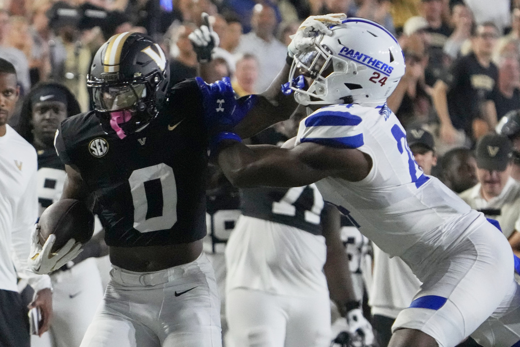 Vanderbilt wide receiver Junior Sherrill (0) gains a first down past Georgia State safety Chandler Jordan (24) after a catch during the first half of an NCAA college football game Saturday, Sept. 20, 2025, in Nashville, Tenn. (AP Photo/George Walker IV)