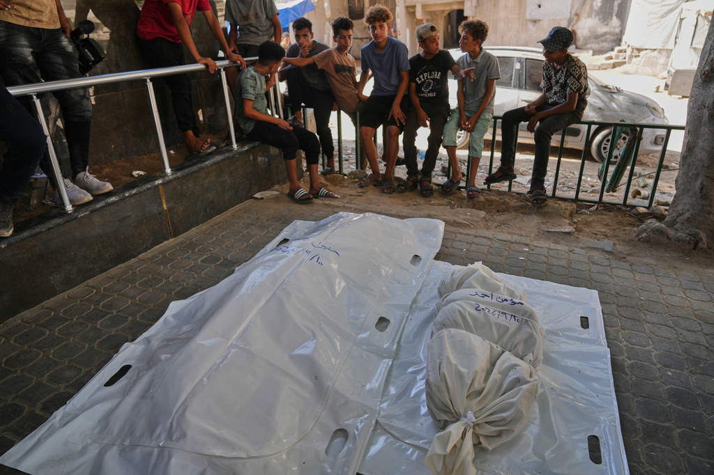 Palestinians gather around the bodies of members of the Ahmed family, including the parents and their two children, who were killed in an Israeli army strike, at Shifa Hospital in Gaza City, Thursday, Sept. 10, 2026. (AP Photo/Jehad Alshrafi)