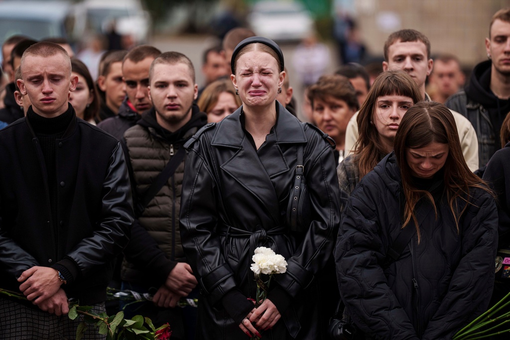 FILE - A woman cries during the funeral ceremony of Ihor Kusochek, a Ukrainian soldier of the Azov brigade in Bobrovytsia, Chernihiv region, Ukraine, Friday, Oct. 4, 2024. (AP Photo/Evgeniy Maloletka, File)
