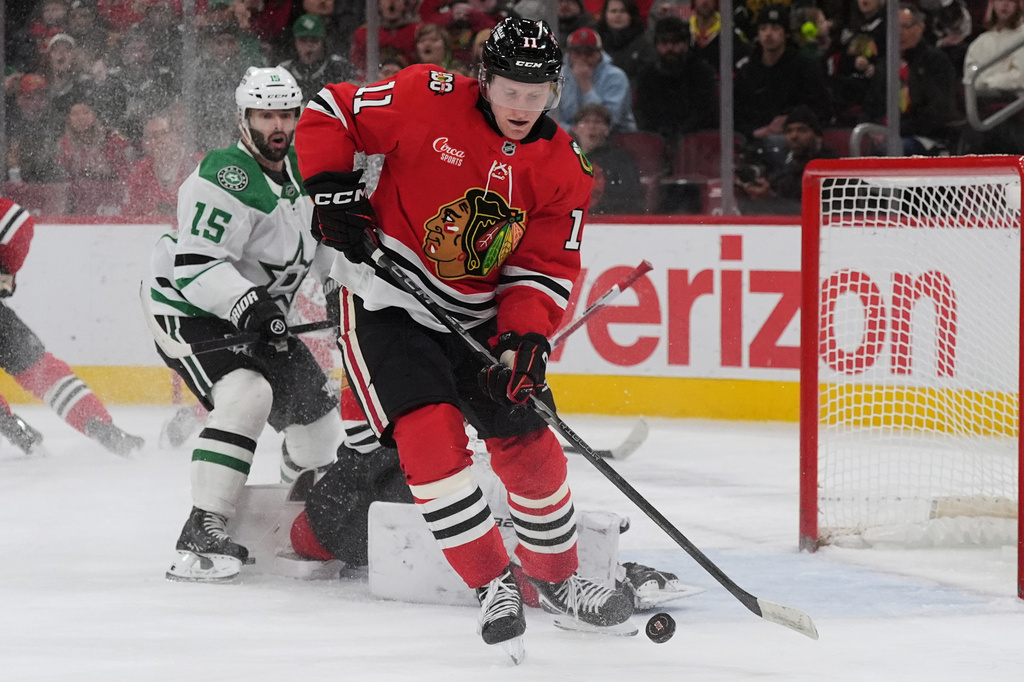 FILE - Chicago Blackhawks center Oliver Moore controls the puck past Dallas Stars center Colin Blackwell (15) during the first period of an NHL hockey game in Chicago, Jan. 1, 2026. (AP Photo/Nam Y. Huh, File)