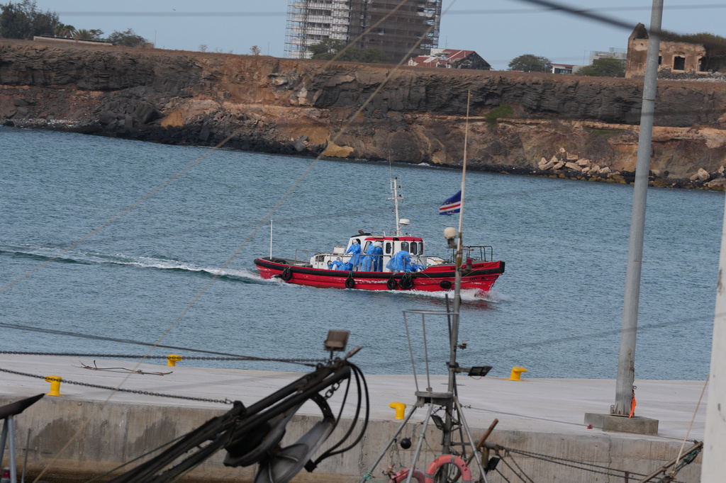 Health workers in protective gear evacuate patients from the MV Hondius cruise ship at a port in Praia, Cape Verde, Wednesday, May 6, 2026. (AP Photo/Misper Apawu)