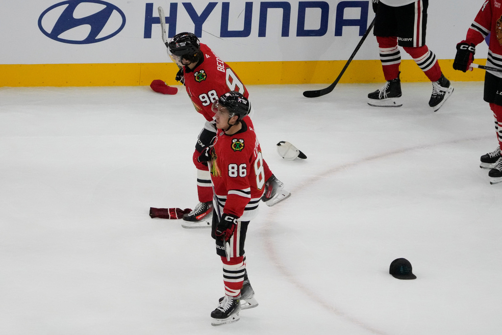 Chicago Blackhawks center Connor Bedard (98) celebrates his hat trick against the Calgary Flames during the third period of an NHL hockey game, Tuesday, Nov. 18, 2025, in Chicago. (AP Photo/David Banks)