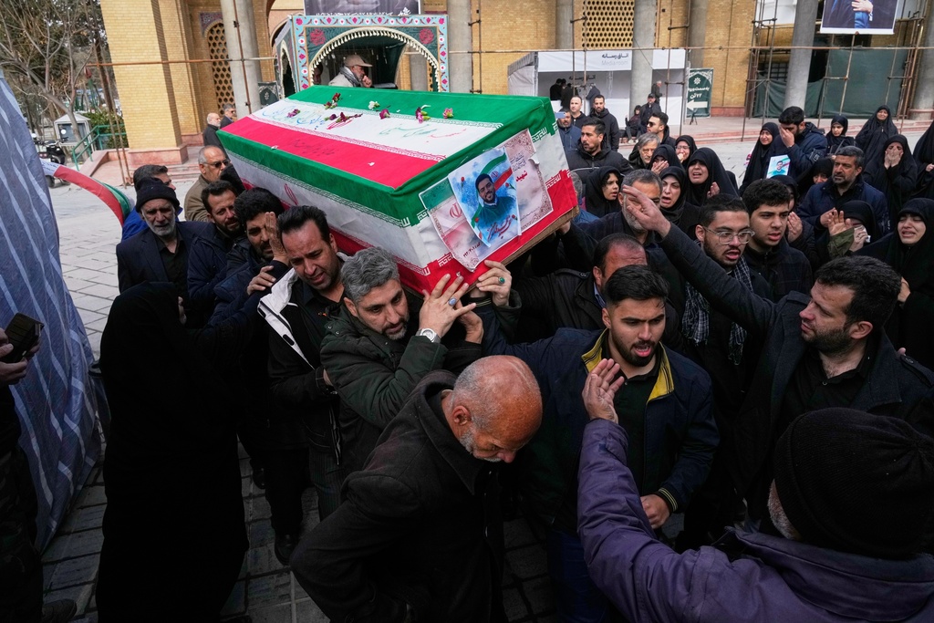 The coffin of Mehdi Hosseini, a man killed in a U.S.-Israeli strike, is carried for burial at Behesht-e Zahra cemetery in Tehran, Iran, Monday, March 9, 2026. (AP Photo/Vahid Salemi)