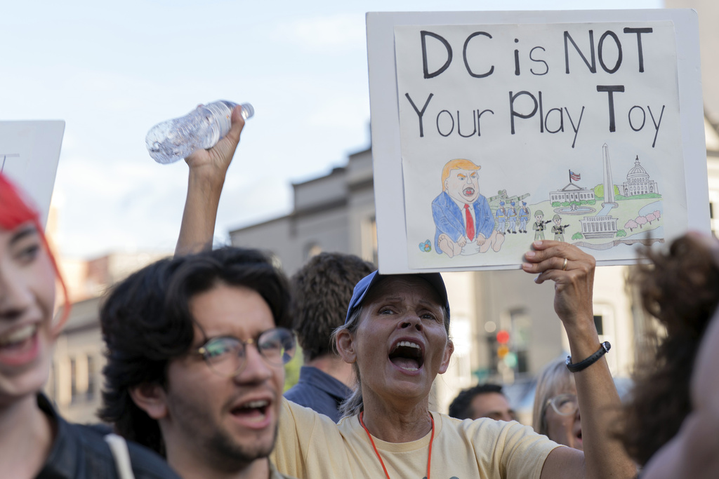 People rally against President Donald Trump's use of federal law enforcement and National Guard troops along the U street corridor in northwest Washington Thursday, Aug. 21, 2025. (AP Photo/Jose Luis Magana)