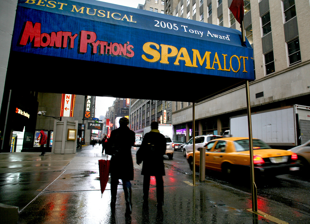 FILE - Pedestrians walk under the marquee of the Broadway show "Monty Python's Spamalot" in New York on Nov. 25, 2008. (AP Photo/Craig Ruttle, File )