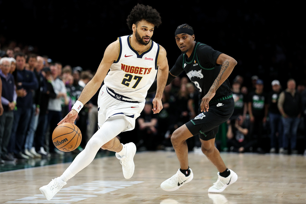 Denver Nuggets guard Jamal Murray, left, works around Minnesota Timberwolves forward Jaden McDaniels, right, during the first half of Game 6 of a first-round NBA basketball playoffs series, Thursday, April 30, 2026, in Minneapolis. (AP Photo/Matt Krohn)