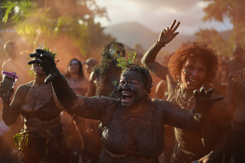 Revelers cheer during the Mud Block carnival party in Paraty, Brazil, Saturday, Feb. 14, 2026. (AP Photo/Andre Penner)