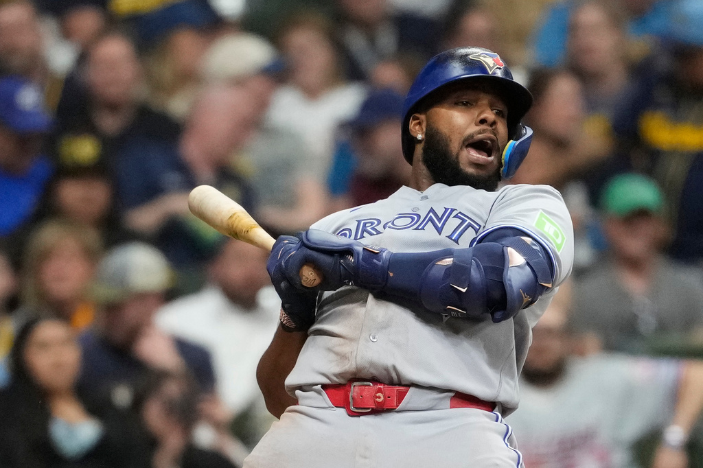 Toronto Blue Jays' Vladimir Guerrero Jr. ducks to avoid being hit by a pitch during the sixth inning of a baseball game against the Milwaukee Brewers, Wednesday, April 15, 2026, in Milwaukee. (AP Photo/Aaron Gash)