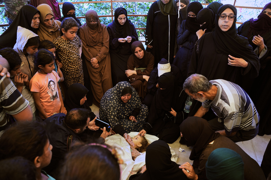 Relatives mourn around the body of 6-year-old Palestinian girl Menna Allah Abu Labda, who was killed in an Israeli airstrike, during her funeral at Nasser Hospital in Khan Younis, Gaza Strip, Monday, May 25, 2026. (AP Photo/Abdel Kareem Hana)