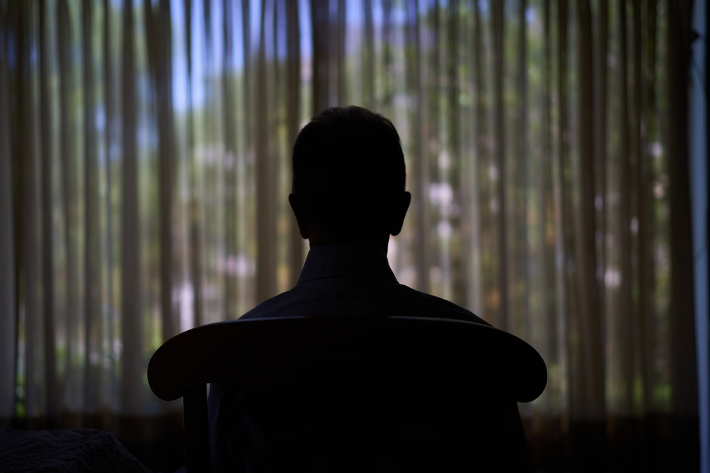 Simon, who was targeted by a scammer that stole $800,000 from his retirement savings and asked not to be identified by his full name because he's too ashamed to tell most of his family about the crime, looks out a window from his home, Wednesday, June 17, 2026, in southeastern New York. (AP Photo/David Goldman)