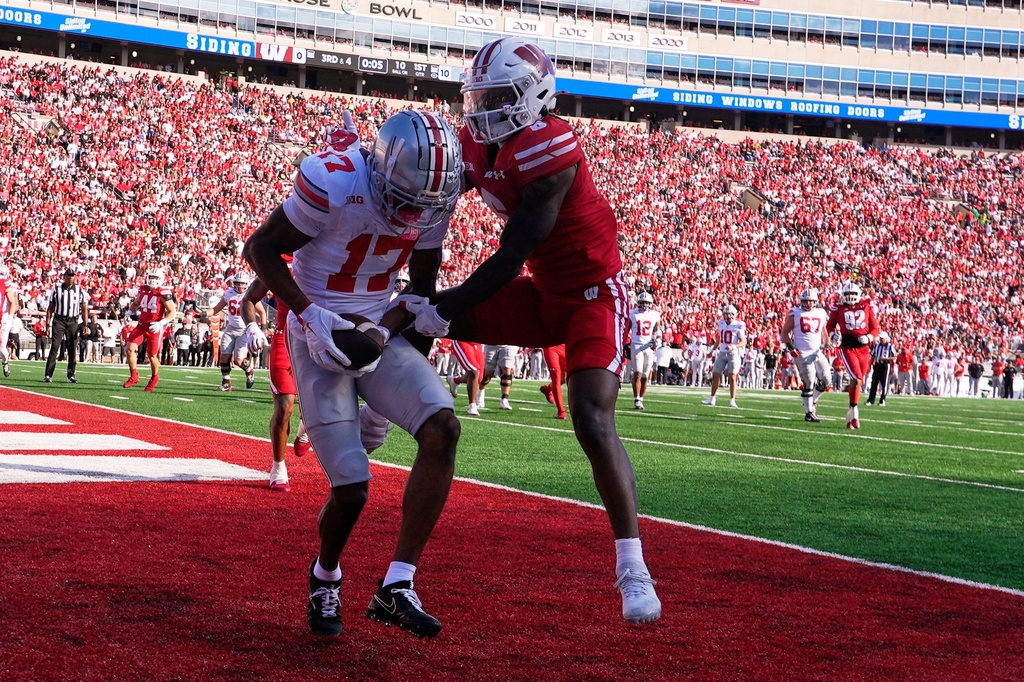 Ohio State's Carnell Tate catches a touchdown pass in front of Wisconsin's Omillio Agard during the first half of an NCAA college football game Saturday, Oct. 18, 2025, in Madison, Wis. (AP Photo/Morry Gash)