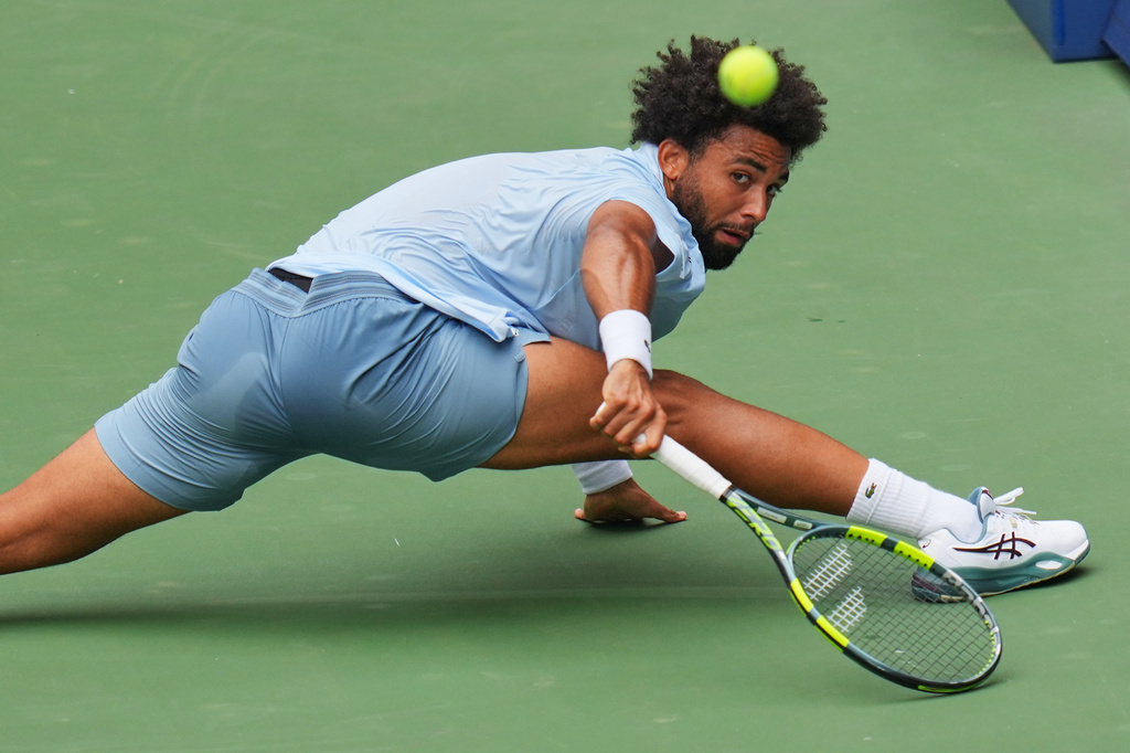 Arthur Fils, of France, lunges to return the ball to Stefanos Tsitsipas, of Greece, during the first round of the U.S. Open tennis championships, Monday, Aug. 31, 2026, in New York. (AP Photo/Kirsty Wigglesworth)