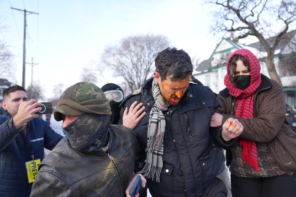Protestors react after being hit with chemical spray at the scene of a shooting in Minneapolis, on Wednesday, Jan. 7, 2026. (Alex Kormann/Star Tribune via AP)