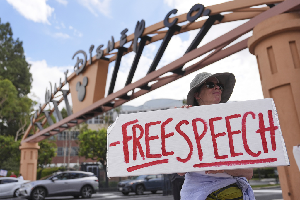 A demonstrator holds a sign in response to the suspension of Jimmy Kimmel's late-night show outside of Walt Disney Studios in Burbank, Calif., on Thursday, Sept. 18, 2025. (AP Photo/Jae C. Hong)