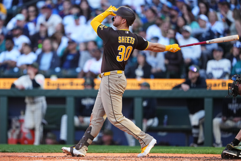 San Diego Padres' Gavin Sheets follows through on a two-run home run against the Seattle Mariners during the sixth inning of a baseball game, Sunday, May 17, 2026, in Seattle. (AP Photo/Lindsey Wasson)