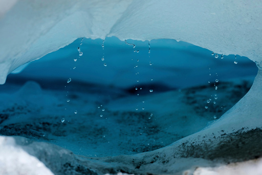 FILE - Water drips from a melting chunk of ice that originated from the Rhone Glacier near Goms, Switzerland, on June 10, 2025. (AP Photo/Matthias Schrader, File) FILE - Water drips from a melting chunk of ice that originated from the Rhone Glacier near Goms, Switzerland, on June 10, 2025. (AP Photo/Matthias Schrader, File)