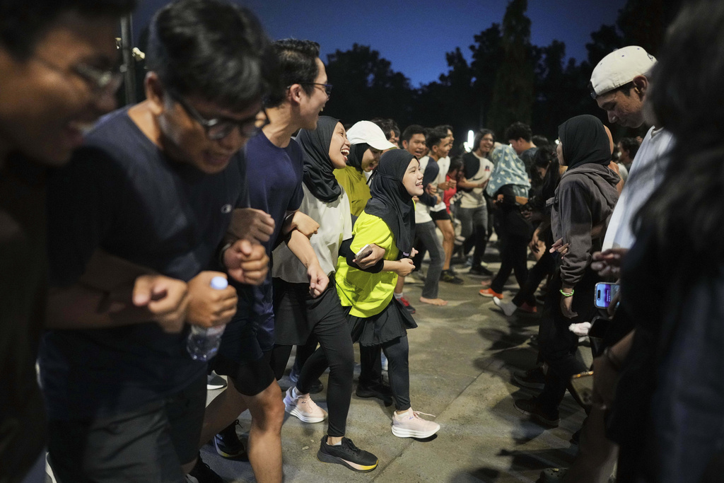 People participate in a community playing gathering in Jakarta, Indonesia, Friday, July 11, 2025. (AP Photo/Dita Alangkara)